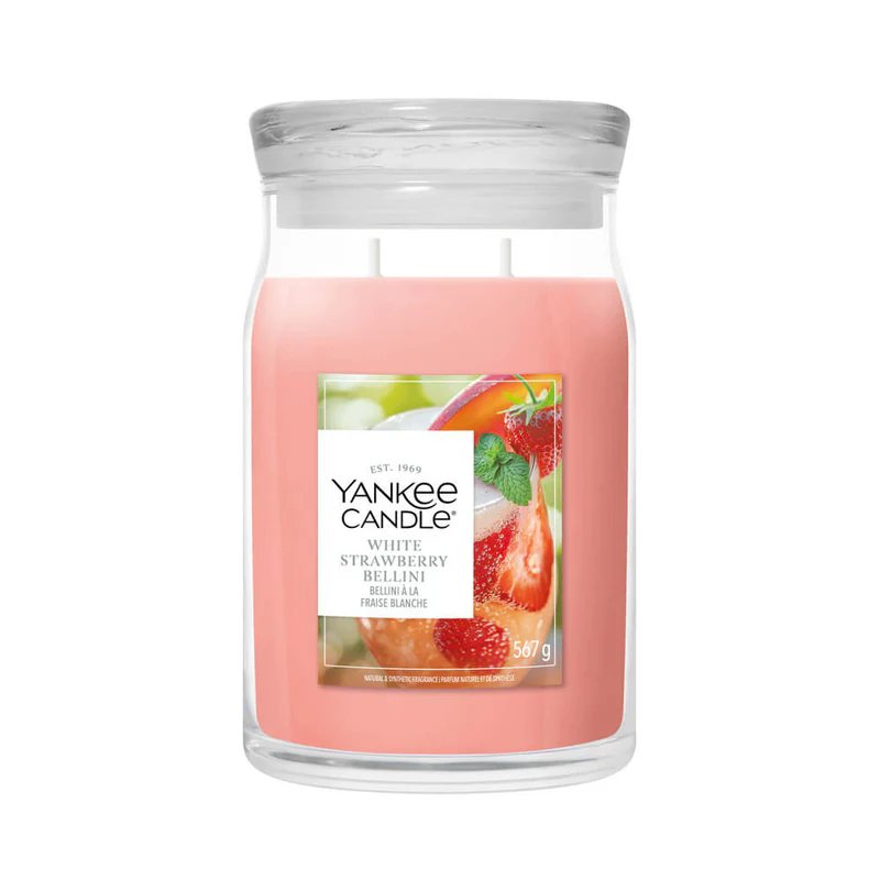 White Strawberry Bellini – Candela Grande – Yankee Candle 350 Punti La candela "White Strawberry Bellini Candela Grande" di Yankee Candle è caratterizzata da cera rosa, un coperchio trasparente e due stoppini. L'etichetta raffigura delle fragole e una bevanda rinfrescante, suggerendo una fragranza fruttata.